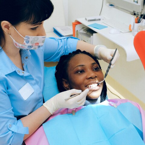 How can we improve access to affordable dental care for low-income individuals?
